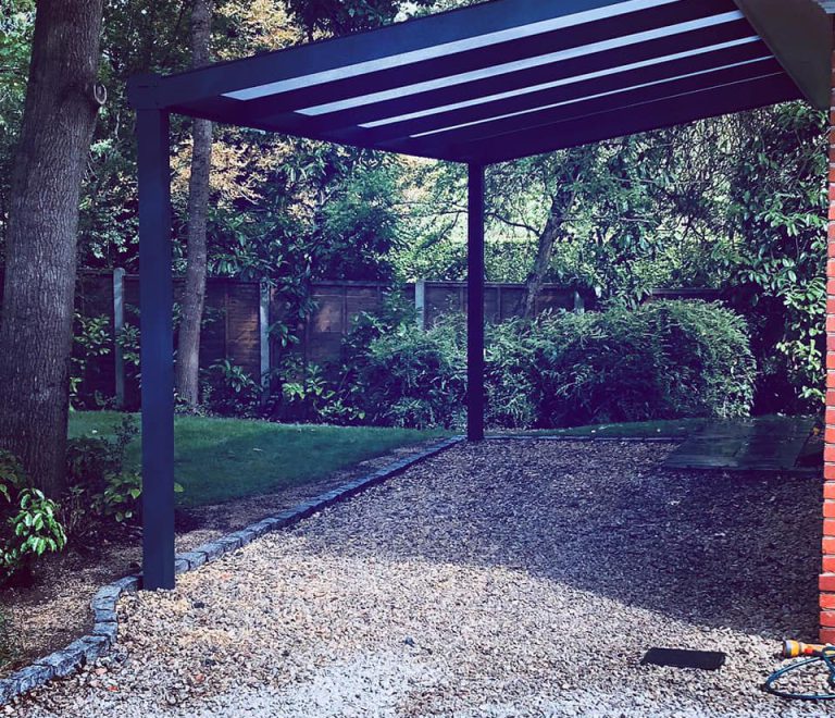 Grey frame lean-to carport vehicle shelter with a polycarbonate roof
